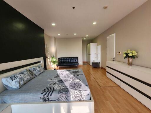 Modern bedroom with stylish decor and ample lighting