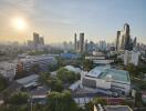 Panoramic cityscape view from a high-rise building at sunset showing an urban skyline