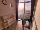 Cozy living area with large window and city view at sunset