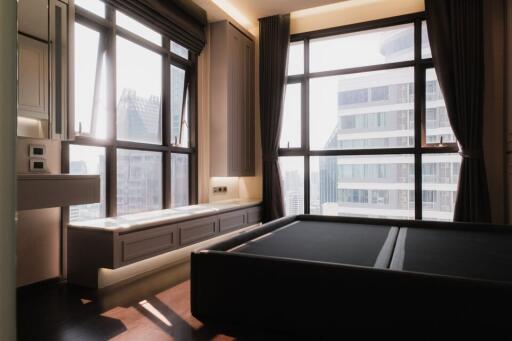 Spacious bedroom with large windows and city view