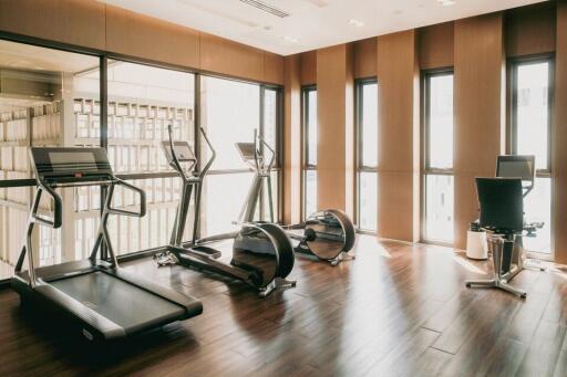 Home gym with modern equipment and large windows