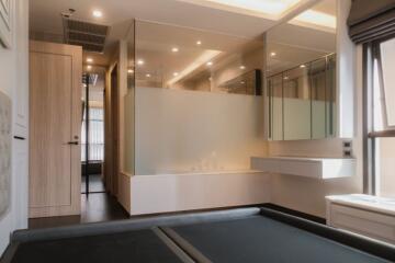 Modern building interior with reflective glass partitions, wooden door, and neutral tones