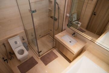 Modern bathroom interior with glass shower and wooden finishes