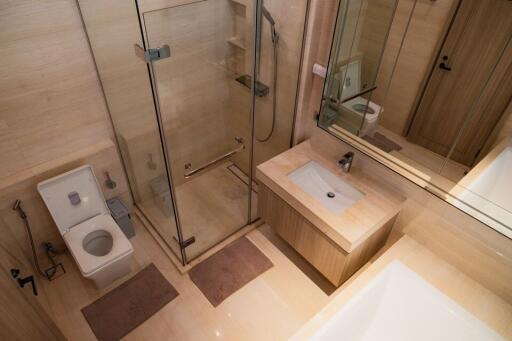 Modern bathroom interior with glass shower and wooden finishes