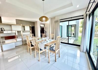 Bright and spacious dining and living area with modern furniture and large windows