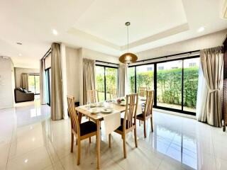 Bright and spacious dining room with large windows and garden view