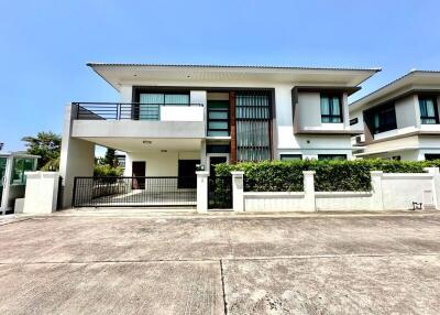 Modern two-story house with spacious driveway and balcony