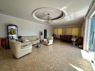 Spacious living room with high ceiling and natural light