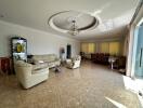 Spacious living room with high ceiling and natural light