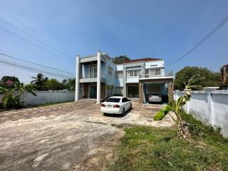 Exterior view of a modern two-story house with spacious driveway