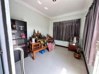 Bright living room with tiled floor and traditional decor