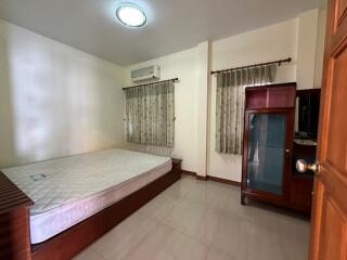 Spacious bedroom with large window and air conditioning