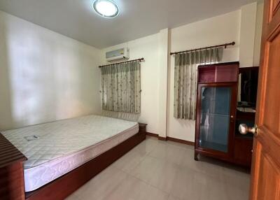 Spacious bedroom with large window and air conditioning