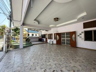 Spacious tiled patio with covered area and ample lighting