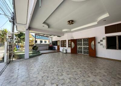 Spacious tiled patio with covered area and ample lighting