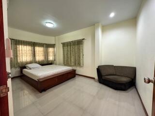 Spacious bedroom with modern furniture and ample lighting