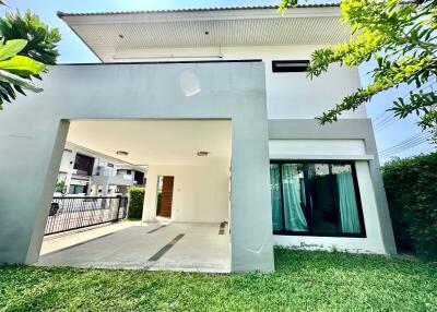 Modern residential exterior with green lawn