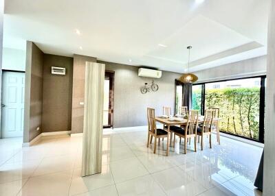 Spacious and bright living room with dining area and large windows