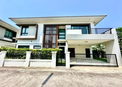 Modern two-story house with white exterior and balcony