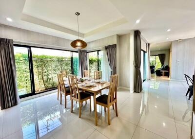 Bright and spacious dining room with large windows and modern decor