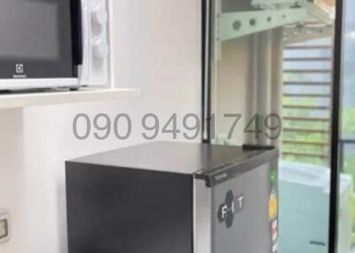 Compact modern kitchen with appliances and balcony access