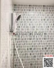 Modern bathroom with a detailed tiled shower wall