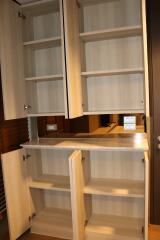 Modern kitchen with open wooden cabinets showing shelving spaces