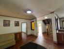 Spacious interior hall with wooden staircase and hardwood floors