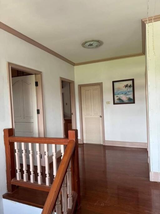 Interior hallway with wooden floors and staircase