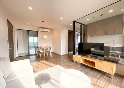 Modern living room with open concept to the kitchen and balcony