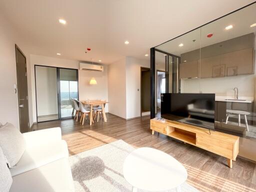 Modern living room with open concept to the kitchen and balcony