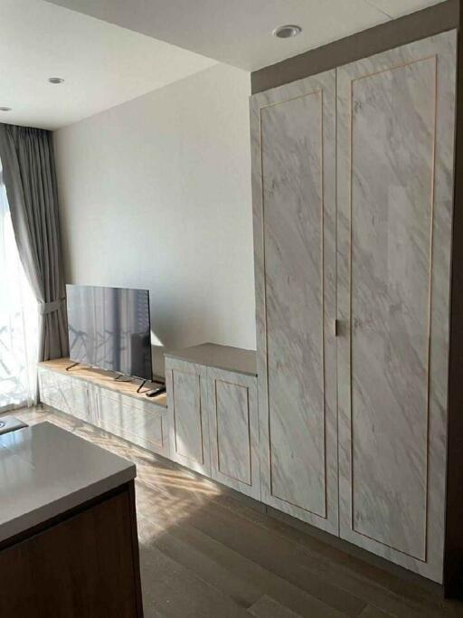 Modern bedroom with built-in marble wardrobe and wooden floor