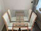 Modern dining area with glass table and chairs