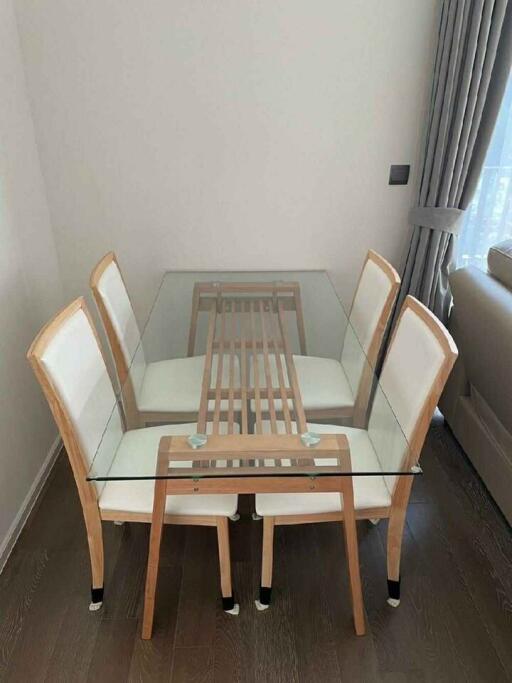 Modern dining area with glass table and chairs