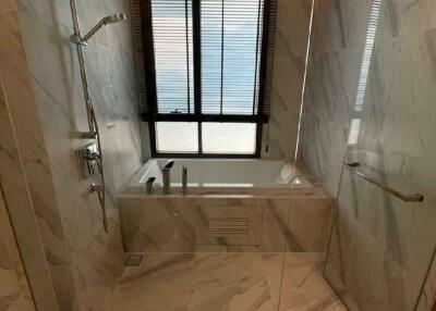 Modern bathroom with marble tiles and natural light