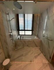 Modern bathroom with marble tiles and natural light