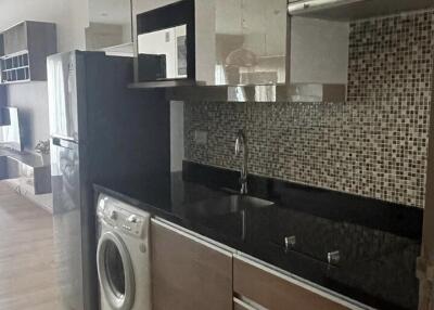 Modern kitchen with stainless steel appliances and mosaic backsplash