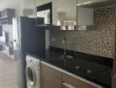 Modern kitchen with stainless steel appliances and mosaic backsplash