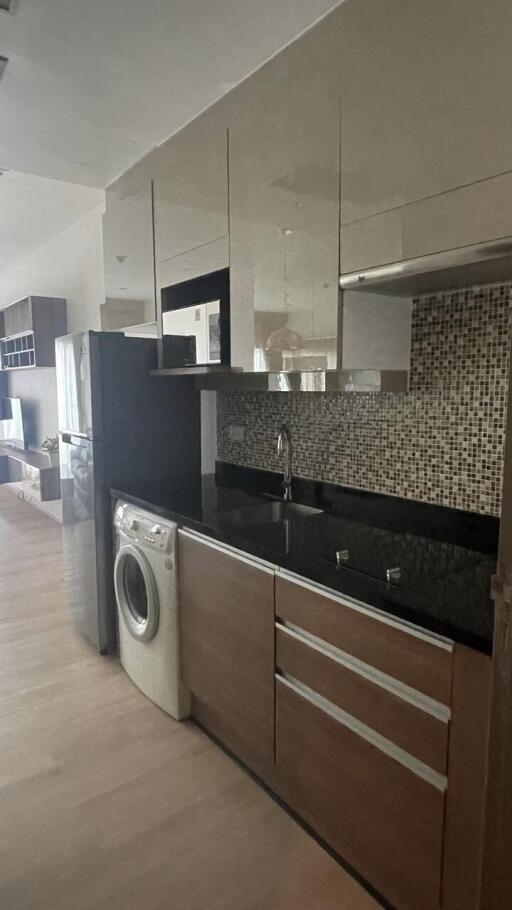 Modern kitchen with stainless steel appliances and mosaic backsplash