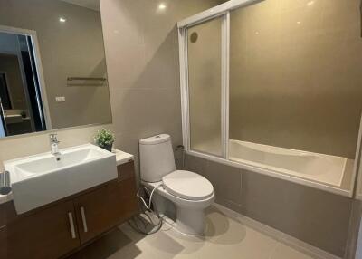 Modern bathroom with bathtub and wooden cabinet