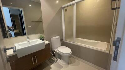 Modern bathroom with bathtub and wooden cabinet