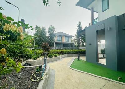 Modern house exterior with landscaped garden and driveway