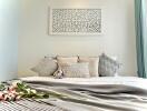 Cozy bedroom interior with decorative pillows and a plush toy on the bed