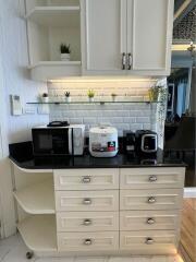 Modern kitchen with built-in appliances and cream cabinets