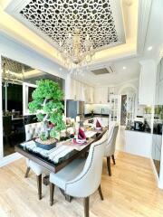 Elegant dining room with chandelier and open concept kitchen