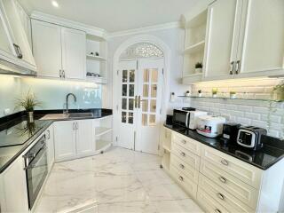 Modern white kitchen with marble flooring