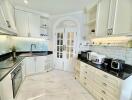 Modern white kitchen with marble flooring