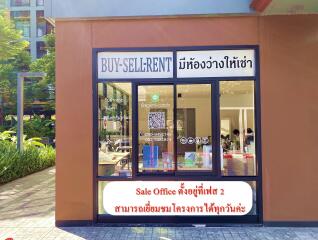 Real estate agency storefront with large windows and advertisement signs