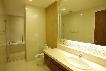 Modern bathroom with glass shower and wooden accents