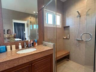 Modern bathroom interior with marble countertop and glass shower